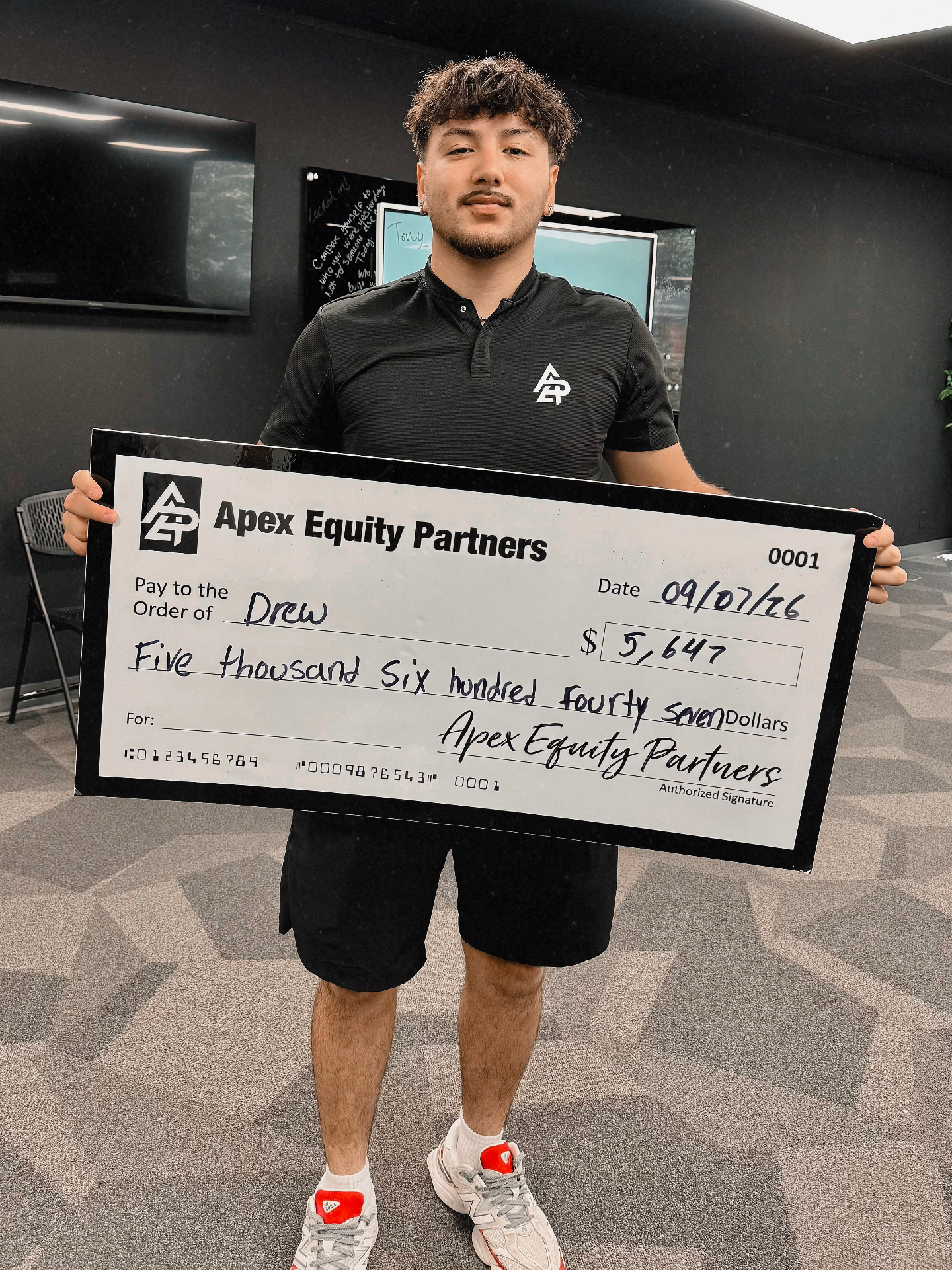 Apex Division rep with a big check