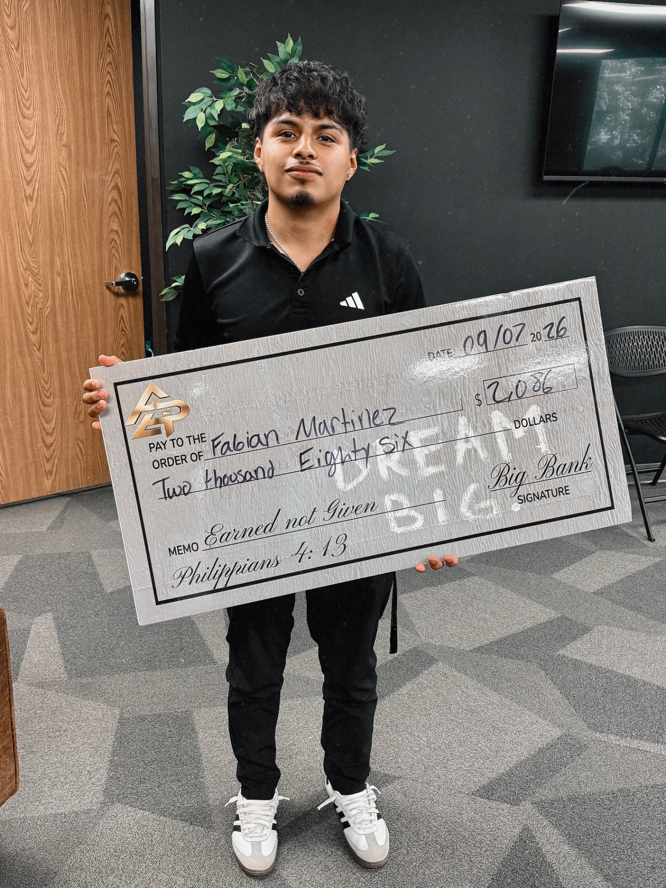 Apex Division rep with a big check